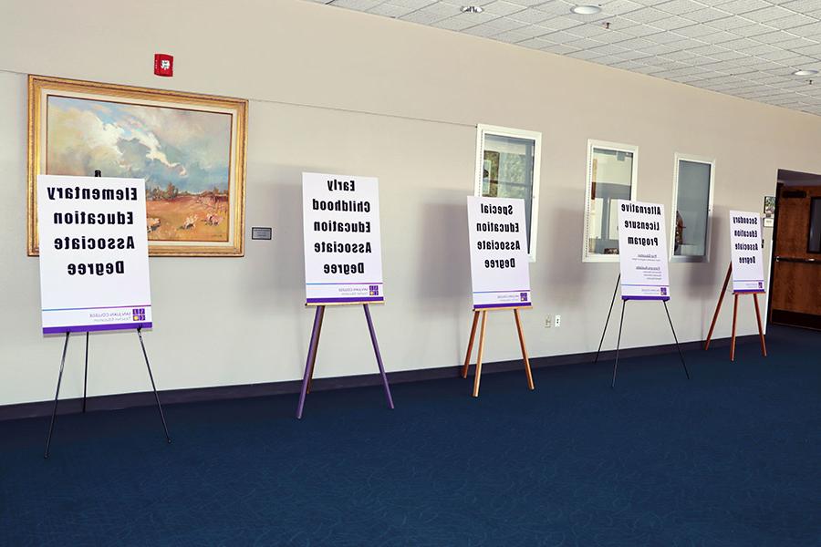 Signage promoting the TeachUp program event is seen in the hallway of the Henderson Fine Arts Center.